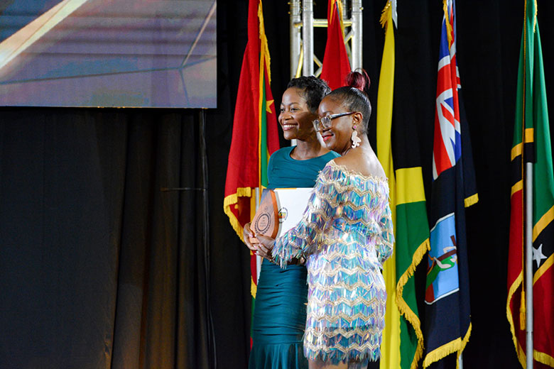 Sheena Warner Edwards presenting to Sashana Small of The Gleaner